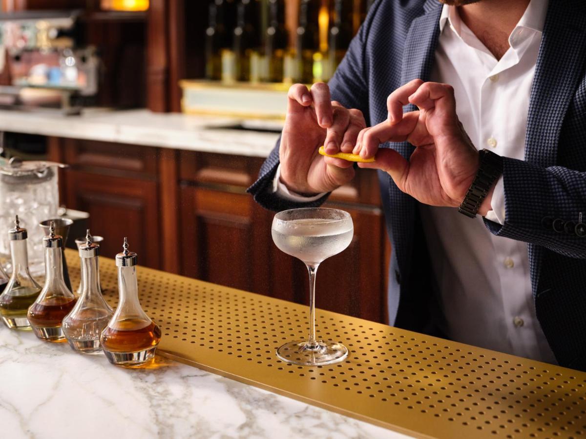 Nomad London Hotel Екстериор снимка A bartender adding a lemon twist to a Vesper cocktail